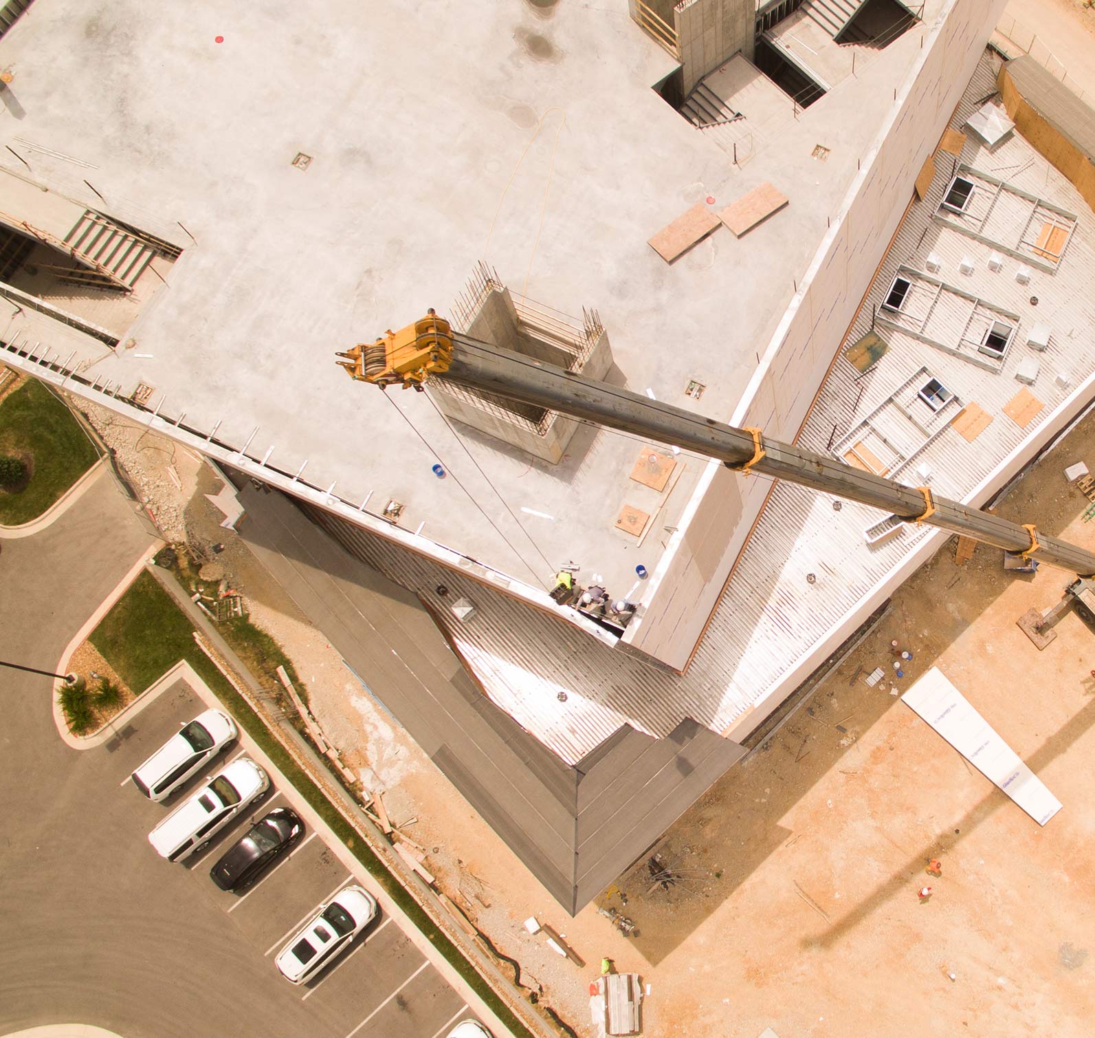 Aerial view of a crane placing metal panels at the WonderWorks building